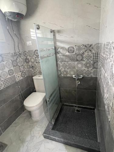 a bathroom with a toilet and a shower at El-kobttan Chalet Sea Veiw - Maamourah in Alexandria
