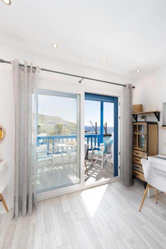 a living room with a large sliding glass door at Bella Vista Mare 1 in Moutsouna Naxos