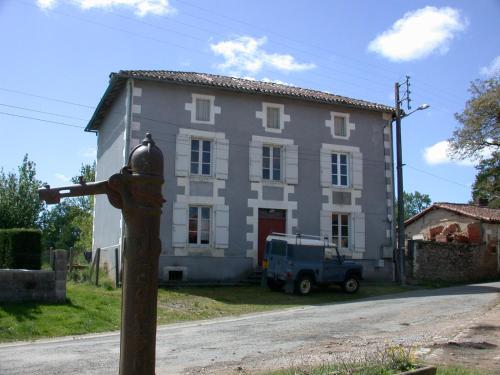 a house with a fire hydrant in front of it at La Maison Bleue in Exideuil