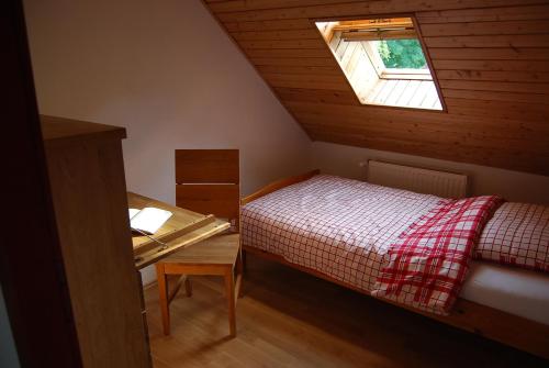 a small bedroom with a bed and a window at Häuschen in Utarp in Utarp