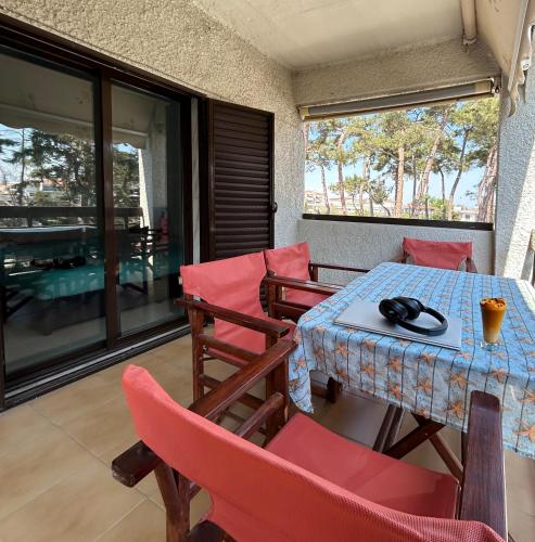 a room with a table and chairs on a balcony at Park Apartment in Neoi Epivates