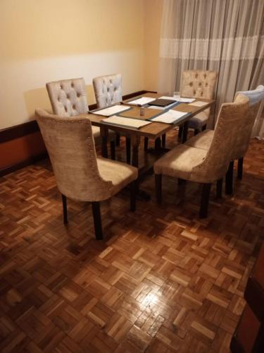 a dining room with a table and chairs at VACAY INTERPRIME AT CANAAN in Nairobi