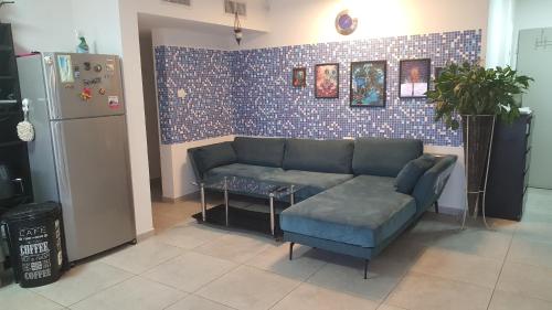 a living room with a couch and a refrigerator at Dream house in Eilat
