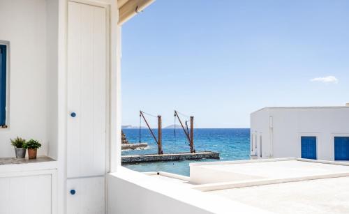 a white house with a view of the ocean at Bella Vista Mare 1 in Moutsouna Naxos