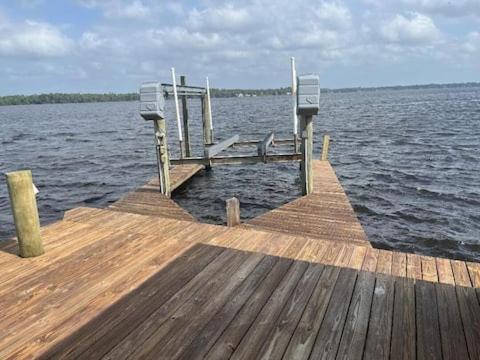 a wooden dock on a body of water at St Johns River Retreat Unit 1 in Crescent City