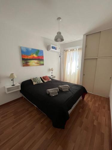 um quarto com uma cama grande com duas toalhas em Rosario centro em Rosário