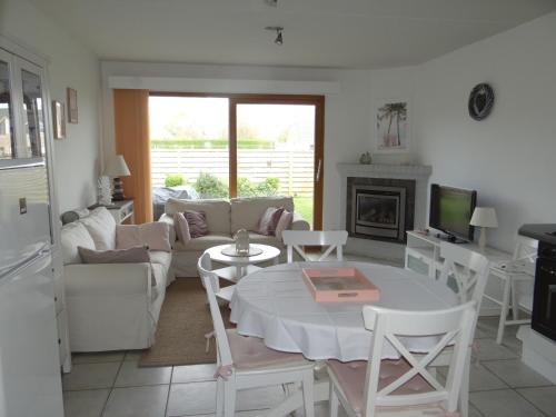 a living room with a couch and a table at Golfbreker in De Haan