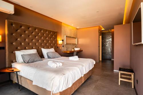 a bedroom with a large bed with towels on it at Villa Grande Arche Istria in Ližnjan