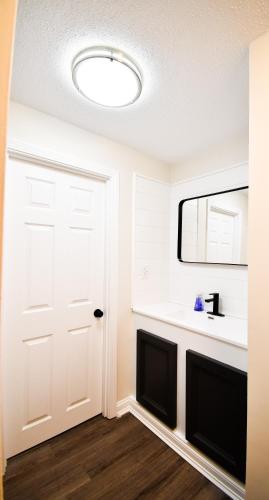 a room with a white door and a mirror at Green Harbor Hotel in Marshfield