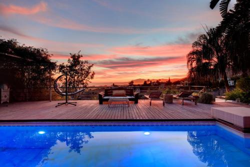 a swimming pool with a sunset in the background at Marbella Boutique Art hotel in Marbella