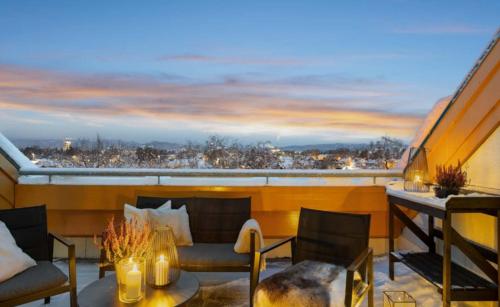 a room with a balcony with a view of a city at Heimdal nær Granåsen in Trondheim