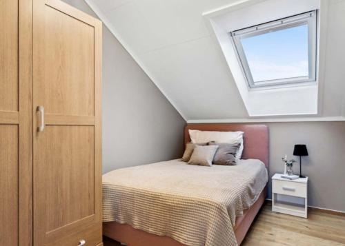 a bedroom with a bed and a window at Heimdal nær Granåsen in Trondheim