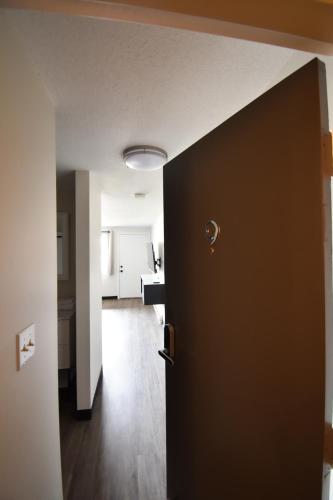 a door leading into a room with a kitchen at Green Harbor Hotel in Marshfield