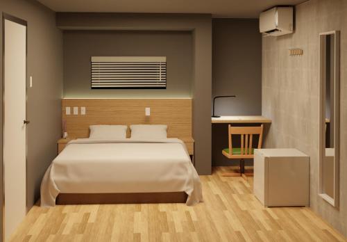 1 dormitorio con 1 cama grande y 1 mesa en My Home Inn Sennan, Onosato en Ozaki