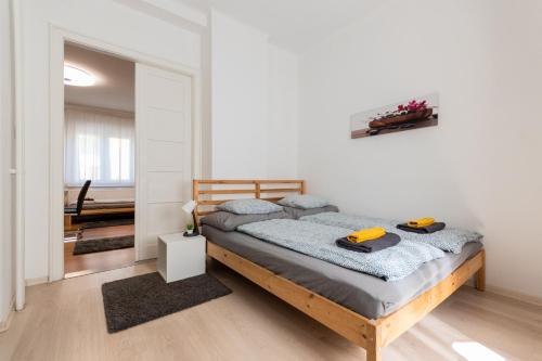 a bedroom with a bed in a white room at B12 Apartment Budapest in Budapest