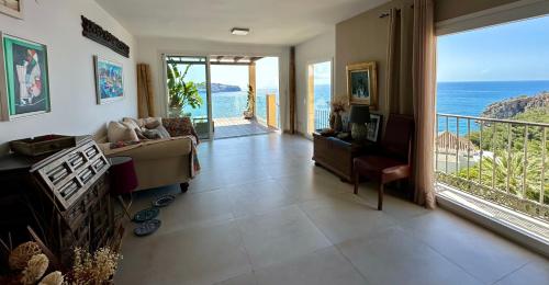 a living room with a view of the ocean at Beautiful House with splendid sea views, Calaiza Beach in La Herradura