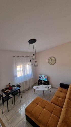 a living room with a couch and a table at Kofinaki apartment 2 in Tycherón