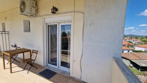 a balcony with a table and a view of a city at Kofinaki apartment 2 in Tycherón