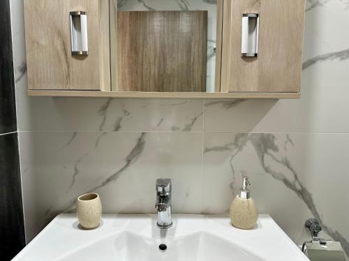 a bathroom with a sink and a mirror at Hercules Studio in Vasiliki