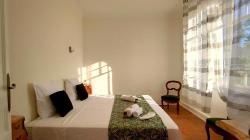 - une chambre avec un lit, une chaise et une fenêtre dans l'établissement A l'Ombre du Jardin YourHostHelper, à Saint-Georges-de-Didonne