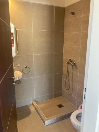 a bathroom with a shower with a toilet and a sink at Casal Sur in Potrero de Garay