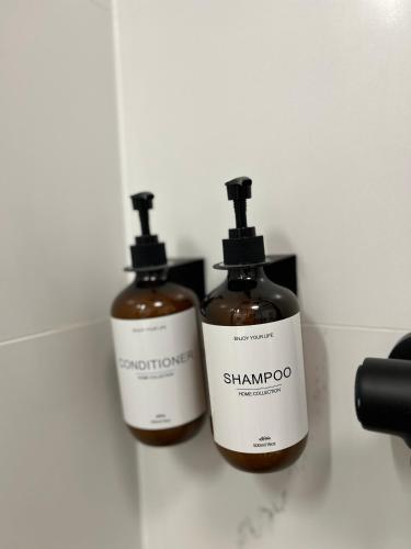 two bottles of shampoo are sitting on a counter at Luxury Apartment PECKA in city centre in Martin