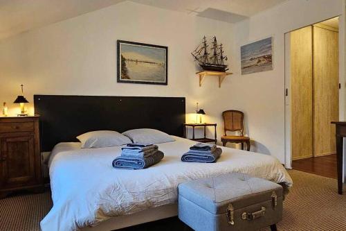 a bedroom with a large bed with blue towels on it at La Belle Vue - Au pied de la Baie - Tout confort in Le Crotoy
