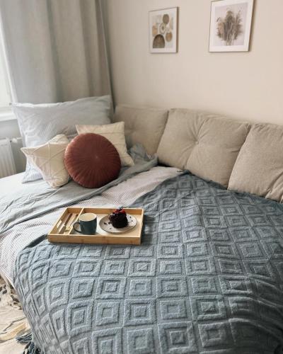 a tray of food sitting on top of a bed at Luxury Apartment PECKA in city centre in Martin