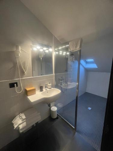 a bathroom with a sink and a shower at Smart Hotel in Carpi