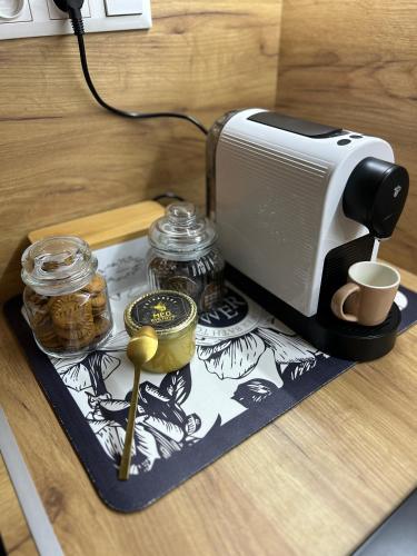 a toaster sitting on top of a table with jars of food at Luxury Apartment PECKA in city centre in Martin