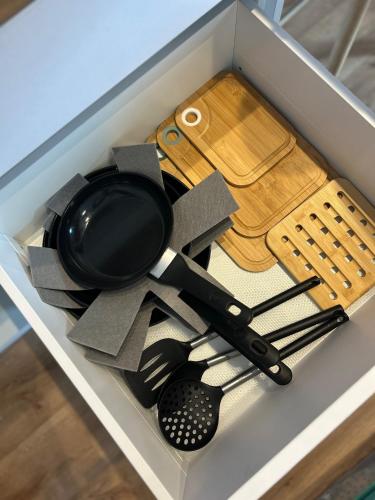 a drawer full of kitchen utensils in a box at Luxury Apartment PECKA in city centre in Martin