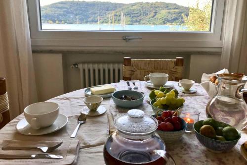 a table with a tea pot and bowls of fruit at Villa Claudia in Portovenere