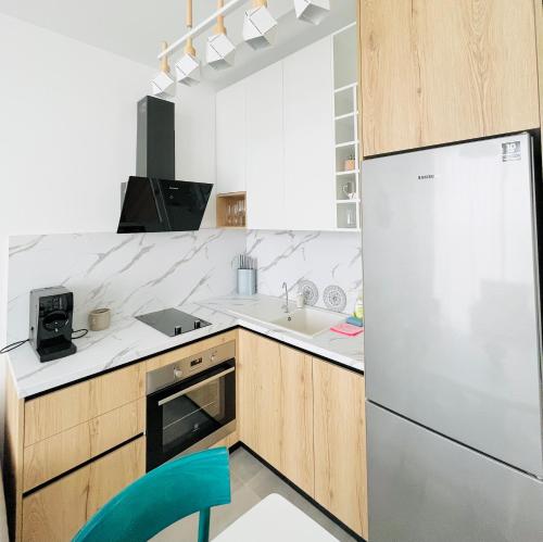 a kitchen with a refrigerator and a sink at Vesper Suites in Dhërmi