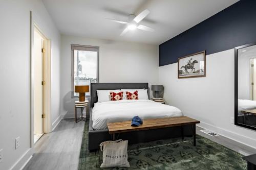 a bedroom with a large bed and a blue wall at Outrider Buyout- 3 units by AvantStay Sleeps 30 in Nashville
