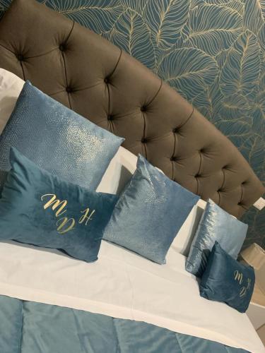 a couch with four blue pillows on it at My Dream House 386 in Angri