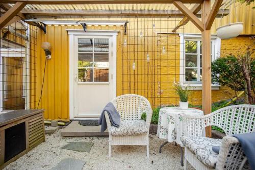 a patio with a table and chairs and a door at Outstanding apartment close to Gothenburg in Kungälv
