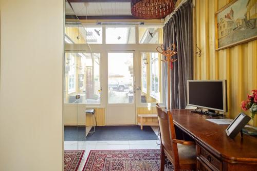 a room with a desk with a computer and a window at Outstanding apartment close to Gothenburg in Kungälv