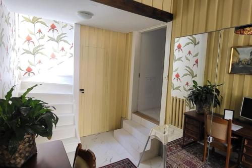 a room with a hallway with a door and a table at Outstanding apartment close to Gothenburg in Kungälv