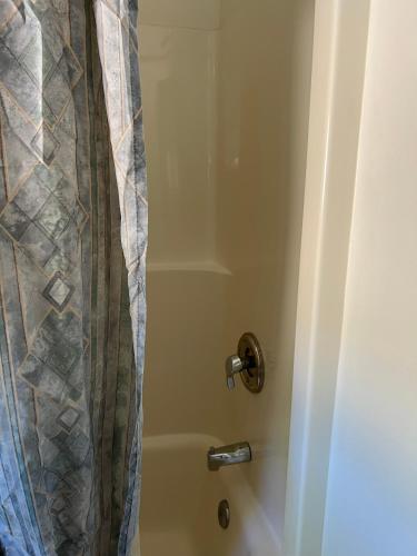 a shower with a shower curtain in a bathroom at Port Townsend Inn in Port Townsend