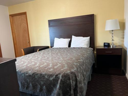 a hotel room with a bed and a lamp at Port Townsend Inn in Port Townsend