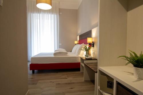 a bedroom with a large bed and a window at Hotel Benacus Torri del Benaco in Torri del Benaco