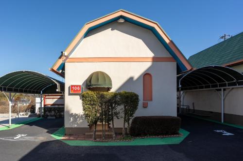 a small building in the middle of a parking lot at Grand Hotel Narita Airport - Vacation STAY 56496v in Narita
