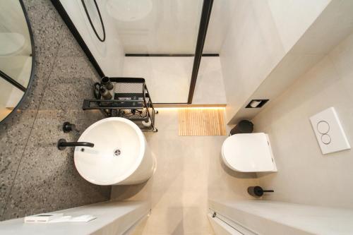 a bathroom with a sink and a mirror at Apartmán Vita Design in Trenčín