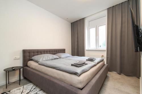 a bedroom with a large bed in front of a window at Apartmán Vita Design in Trenčín