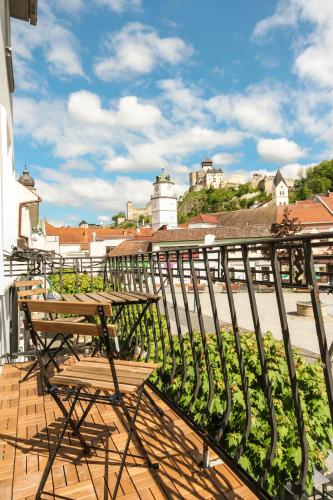 a balcony with a table and chairs on a roof at Apartmán Vita Design in Trenčín