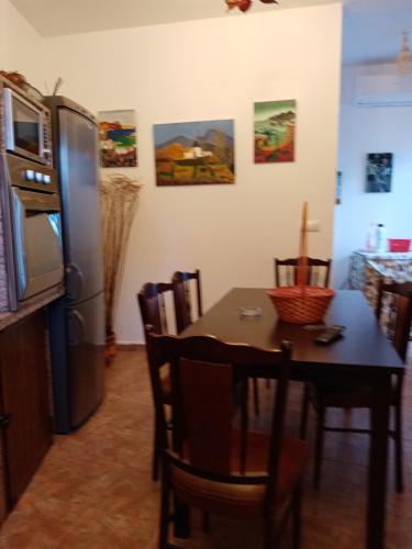 a kitchen with a table and a refrigerator at Casa Caremy in Almería