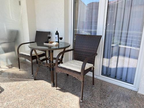 two chairs and a table on a balcony at Villa Dislievski in Ohrid