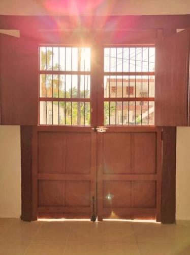 an empty garage with two doors and two windows at Casa Colibri Central Villa with Private Pool and Tub Merida in Mérida