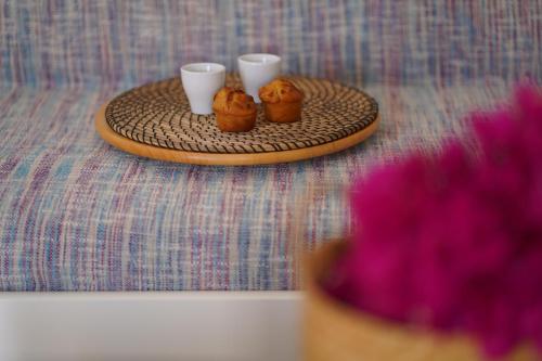 a table with a tray with three cupcakes on it at Paradise Apartments in Ferma