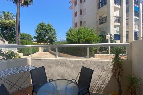 a balcony with a table and chairs and a building at Apartamento Calalbir in Albir